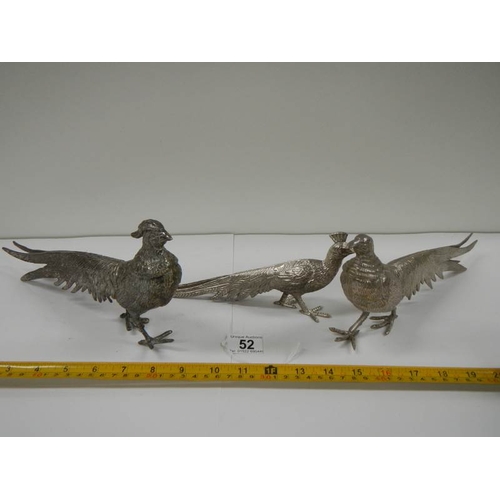 52 - A pair of silver plated pheasants and one other.