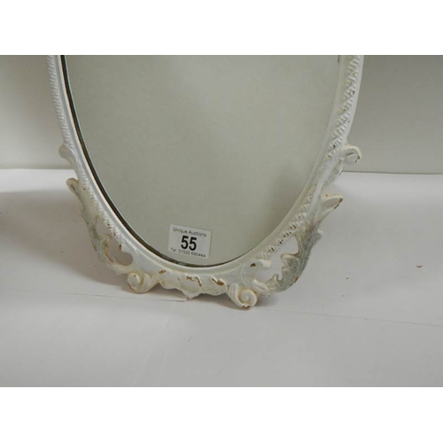 55 - A mid 20th century metal framed oval mirror, in good condition (19'' tall).