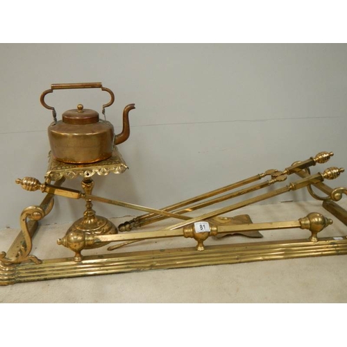 81 - A Victorian brass fender, set of brass fire irons, brass trivet and copper kettle.