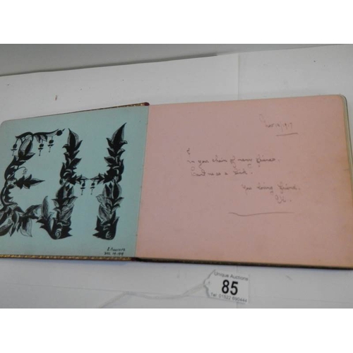 85 - An early 20th century autograph book with many drawings and watercolours.