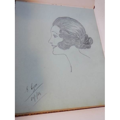 85 - An early 20th century autograph book with many drawings and watercolours.