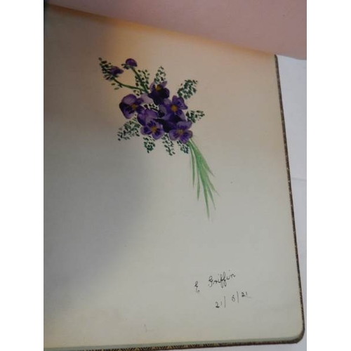 85 - An early 20th century autograph book with many drawings and watercolours.