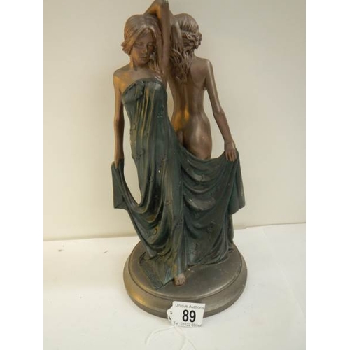 89 - An art deco style figure of a semi nude and a nude lady, 12.5'' tall.