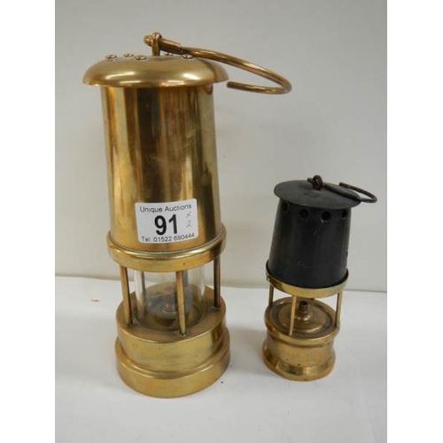 91 - 2 old miner's lamps, one brass and the other brass and steel marked W & P B 23573109