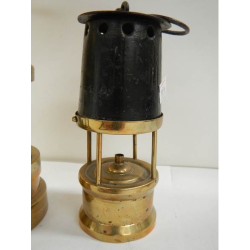 91 - 2 old miner's lamps, one brass and the other brass and steel marked W & P B 23573109