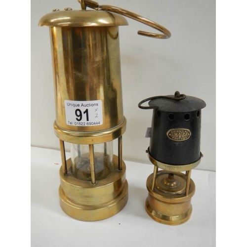 91 - 2 old miner's lamps, one brass and the other brass and steel marked W & P B 23573109