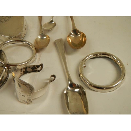 94 - A mixed lot of silver lids for glass bottles etc., silver spoons etc., 11 items in total weight 180g