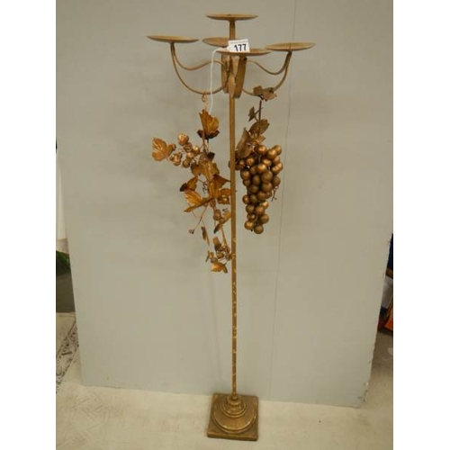 177 - A tall gilded candle holder with embellishments, 43'' tall.