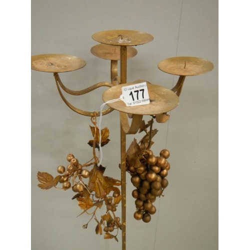 177 - A tall gilded candle holder with embellishments, 43'' tall.