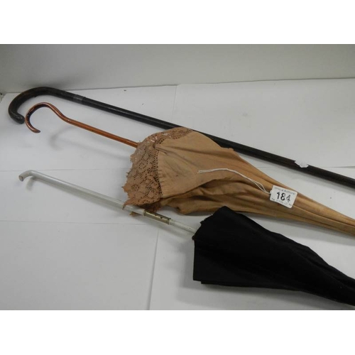 184 - A walking stick with silver mounts and 2 parasols.