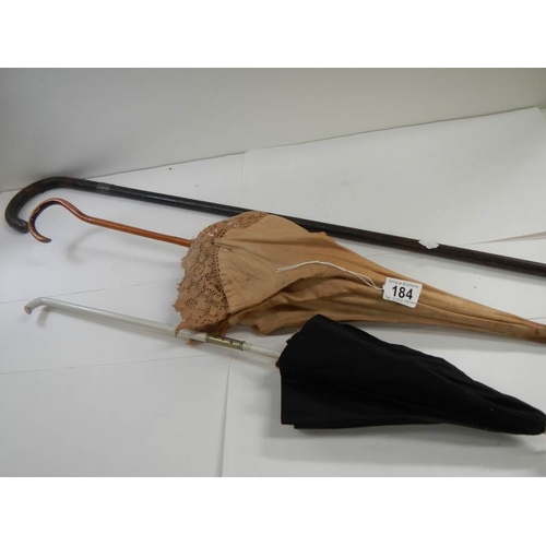 184 - A walking stick with silver mounts and 2 parasols.