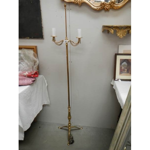 186 - A 20th century brass standing lamp in gilded rope design, 60'' tall and in good condition.