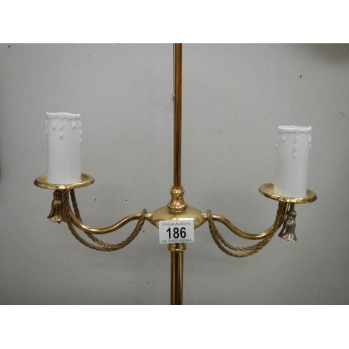 186 - A 20th century brass standing lamp in gilded rope design, 60'' tall and in good condition.