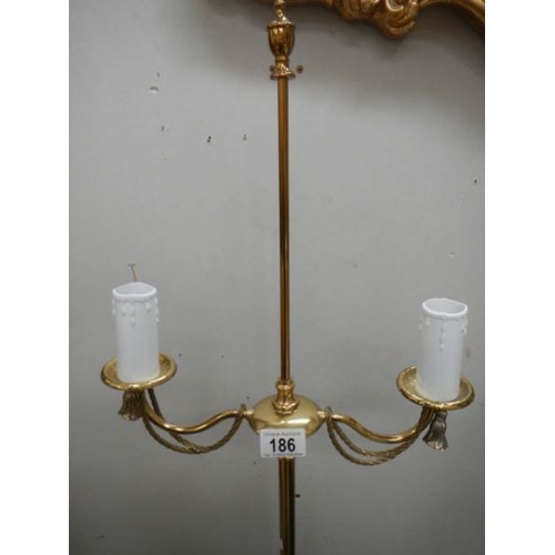 186 - A 20th century brass standing lamp in gilded rope design, 60'' tall and in good condition.