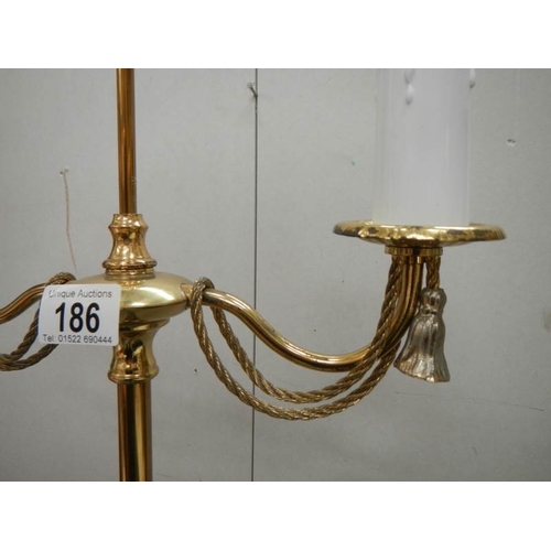 186 - A 20th century brass standing lamp in gilded rope design, 60'' tall and in good condition.