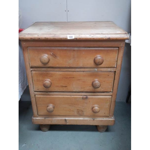 188 - An antique 3 drawer pine chest on bun feet, 33'' tall x 25'' wide