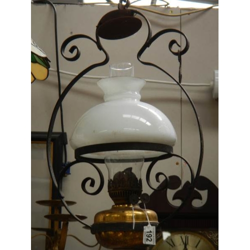 192 - An early 20th century hanging oil lamp, complete.