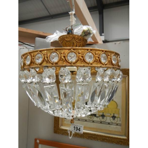 194 - A good quality brass and glass chandelier 12'' diameter x 11'' drop.