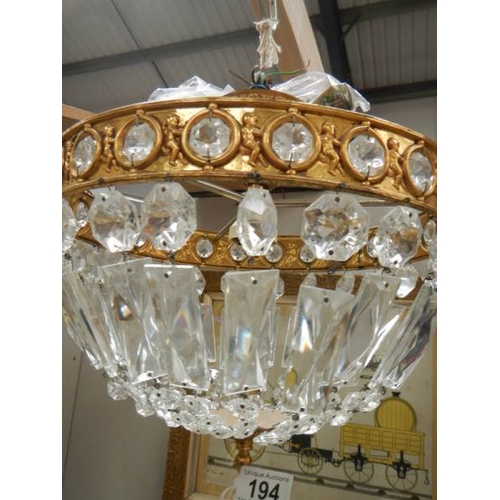 194 - A good quality brass and glass chandelier 12'' diameter x 11'' drop.