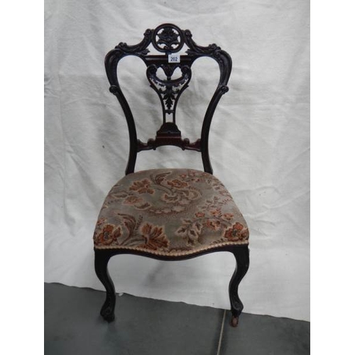 202 - A Victorian carved nursing chair,