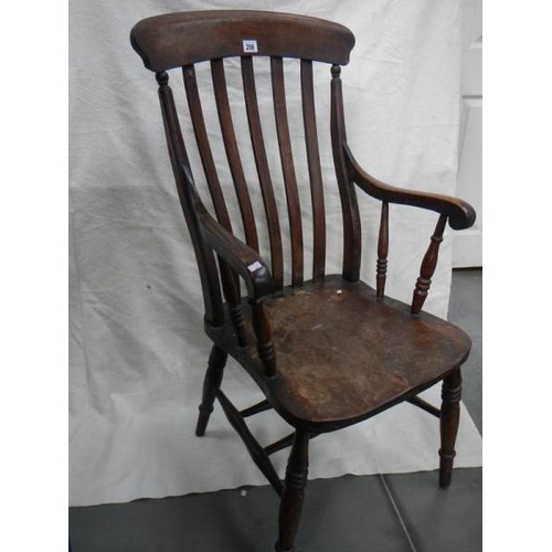 206 - A Victorian slat back Windsor arm chair.