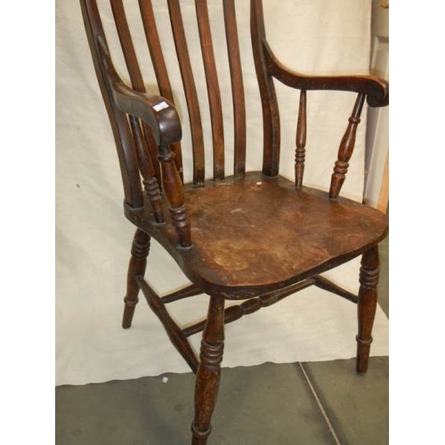 206 - A Victorian slat back Windsor arm chair.