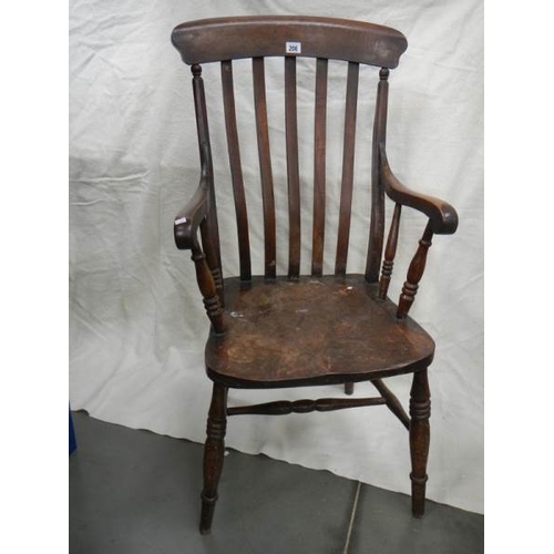 206 - A Victorian slat back Windsor arm chair.