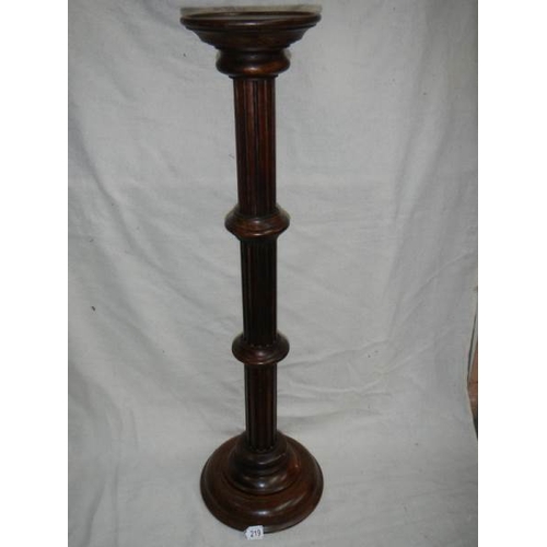 219 - A mahogany torchere, 40'' tall