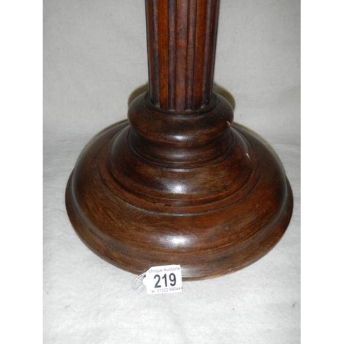 219 - A mahogany torchere, 40'' tall