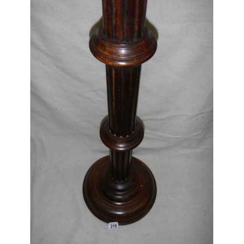 219 - A mahogany torchere, 40'' tall