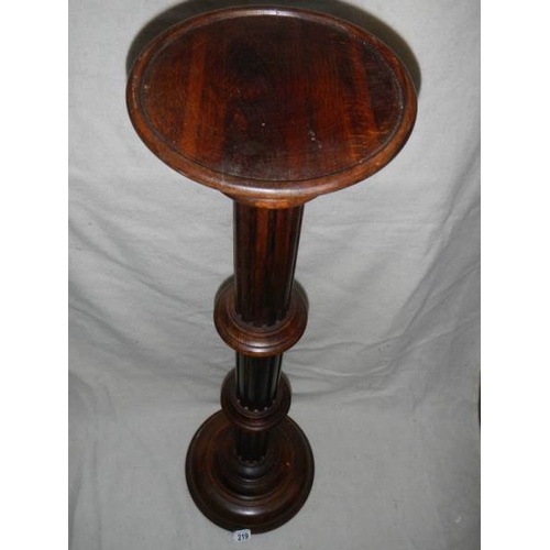 219 - A mahogany torchere, 40'' tall