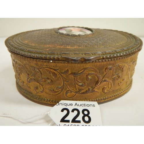 228 - A Victorian French oval metal box with hand painted plaque, 5'' wide.