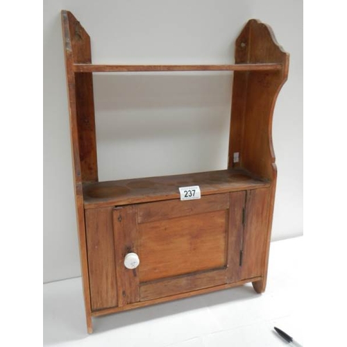 237 - An old pine kitchen cabinet with opening door, 15'' wide.