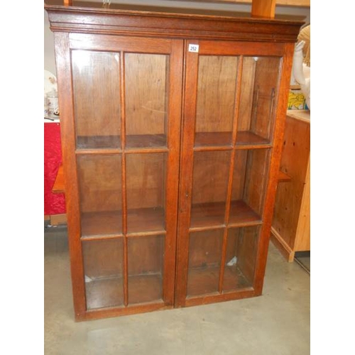 252 - A good oak 2 door bookcase,  high, in good condition.