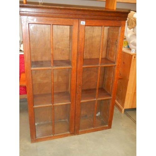 252 - A good oak 2 door bookcase,  high, in good condition.