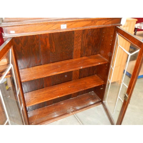 253 - An oak 2 door leaded book case,  35'' wide x 38'' high,