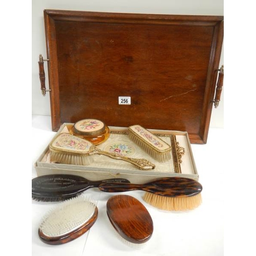 256 - An oak serving tray, a dressing table set (unused), and advertising brush and one other etc.,