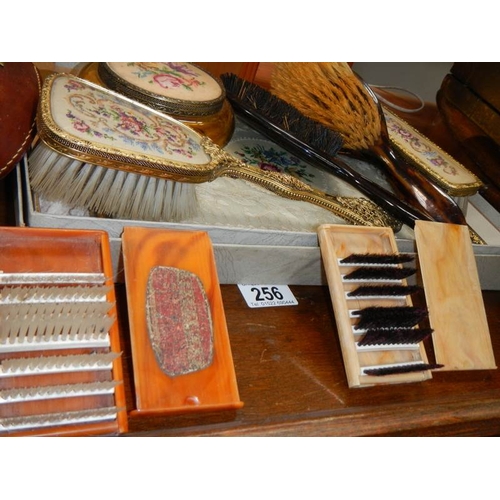 256 - An oak serving tray, a dressing table set (unused), and advertising brush and one other etc.,