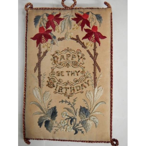 257 - An excellent embroidered panel with religious text and a pincushion (happy birthday).