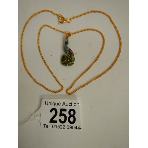 258 - An enamelled peacock pendant on plated chain.