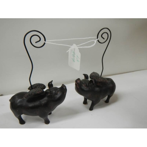 267 - 2 ceramic pocket watch stands in the form of flying pigs.