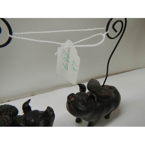 267 - 2 ceramic pocket watch stands in the form of flying pigs.