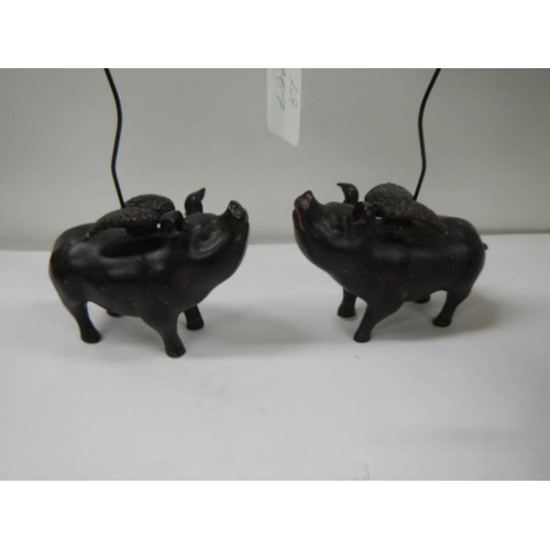 267 - 2 ceramic pocket watch stands in the form of flying pigs.