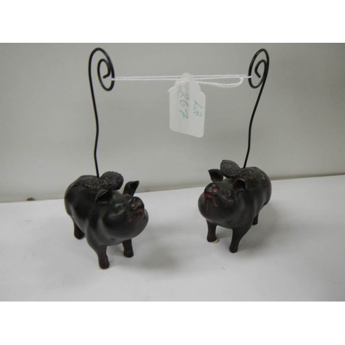 267 - 2 ceramic pocket watch stands in the form of flying pigs.