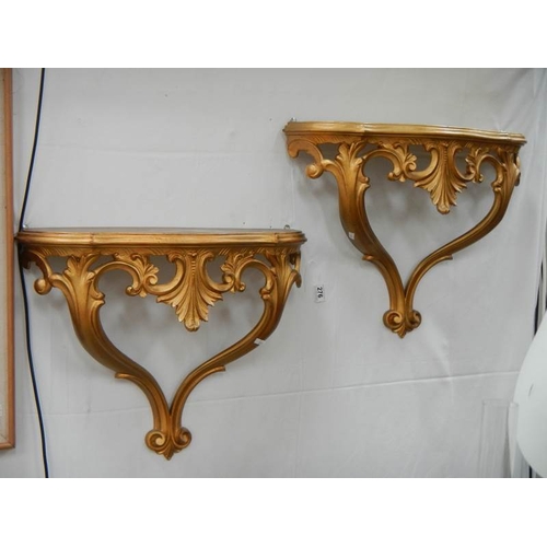 276 - A pair of gilded wall brackets.