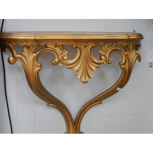 276 - A pair of gilded wall brackets.