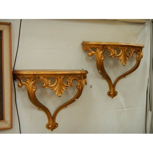 276 - A pair of gilded wall brackets.