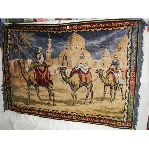 283 - A large wall hanging of camels, good colours, 6' x 4'