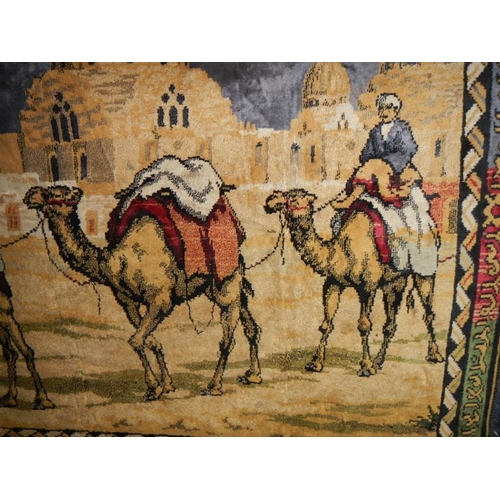 283 - A large wall hanging of camels, good colours, 6' x 4'