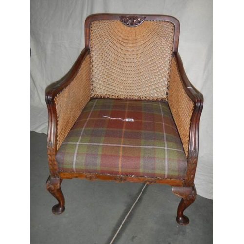 286 - A Victorian mahogany bergere arm chair in excellent condition and with extra cushion.